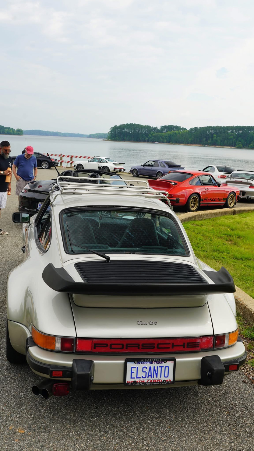 Silver air-cooled Porsche 911 Turbo with ELSANTO plates at a lakeside car meet